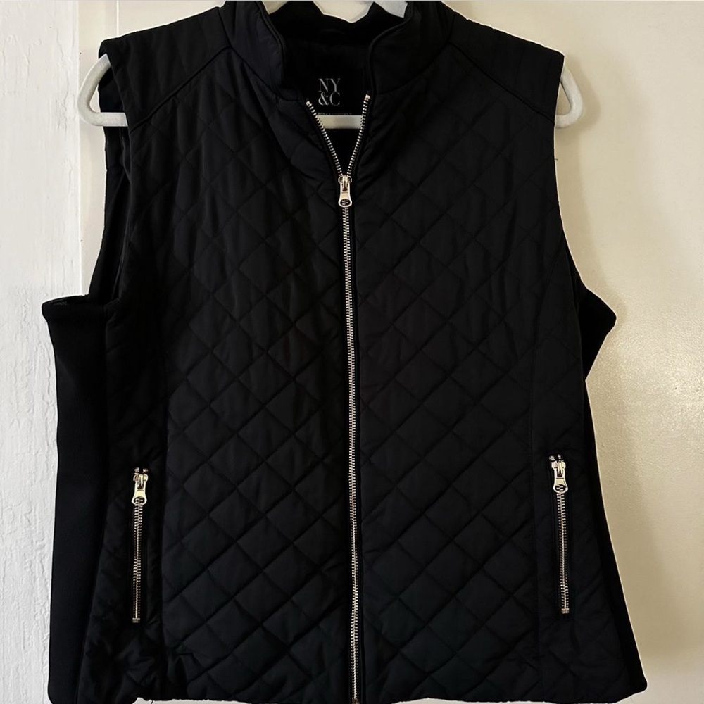 Black quilted vest with silver zipper details